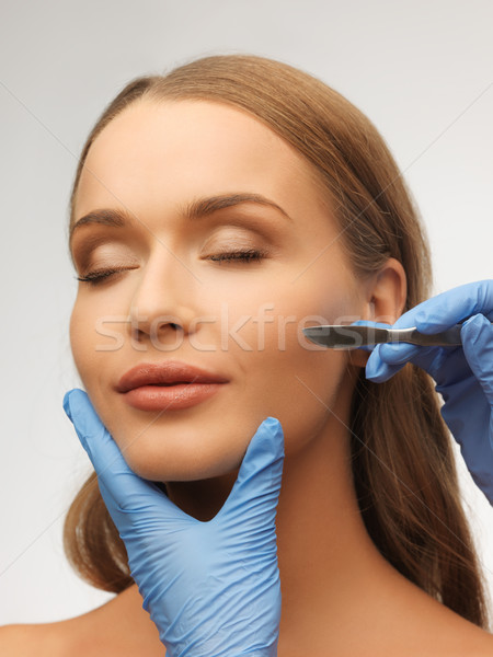 woman face and beautician hands Stock photo © dolgachov
