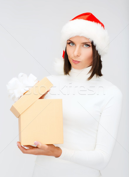 Stock photo: suspicious woman in santa helper hat with gift box