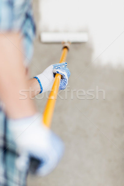 man colouring the wall with roller Stock photo © dolgachov