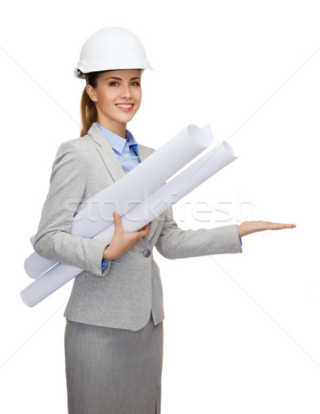smiling architect in white helmet with blueprints Stock photo © dolgachov