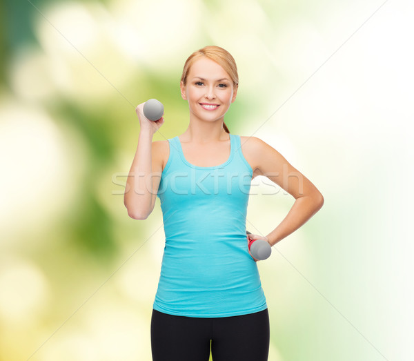 Jovem mulher luz halteres esportes Foto stock © dolgachov