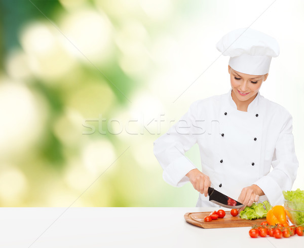smiling female chef chopping vagetables Stock photo © dolgachov