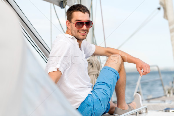 man sitting on yacht deck Stock photo © dolgachov