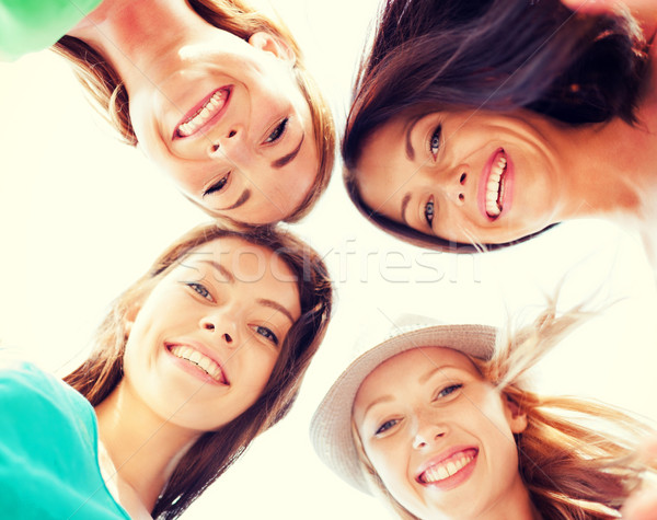 faces of girls looking down and smiling Stock photo © dolgachov
