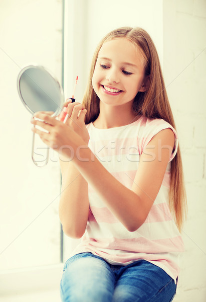 teenage girl with lip gloss and mirror Stock photo © dolgachov