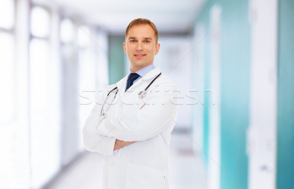smiling male doctor in white coat with stethoscope Stock photo © dolgachov