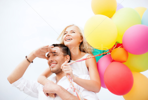 couple with colorful balloons at seaside Stock photo © dolgachov