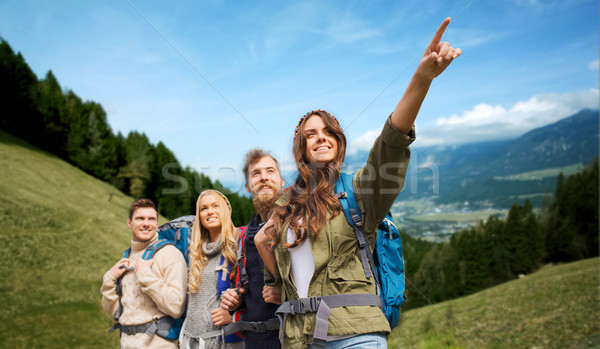 group of smiling friends with backpacks hiking Stock photo © dolgachov