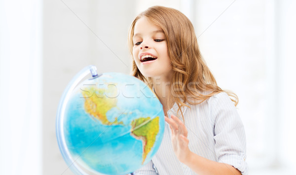 student girl with globe at school Stock photo © dolgachov