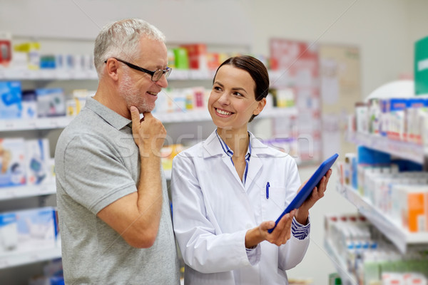 Stock photo: pharmacist with tablet pc and senior man