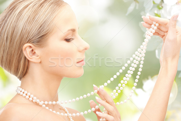 woman with pearl necklace over cherry blossom Stock photo © dolgachov