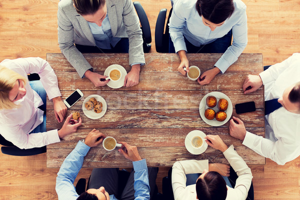 close up of business team drinking coffee on lunch Stock photo © dolgachov