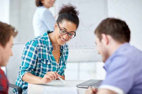 group of happy high school students with workbook Stock photo © dolgachov