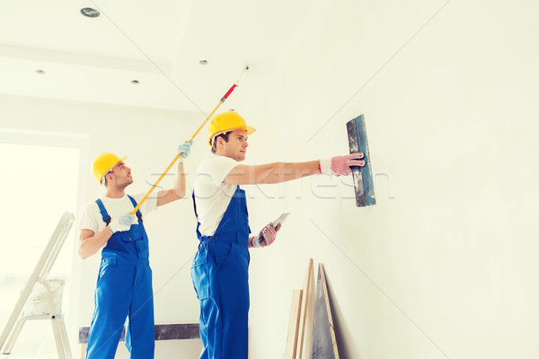 group of builders with tools indoors Stock photo © dolgachov