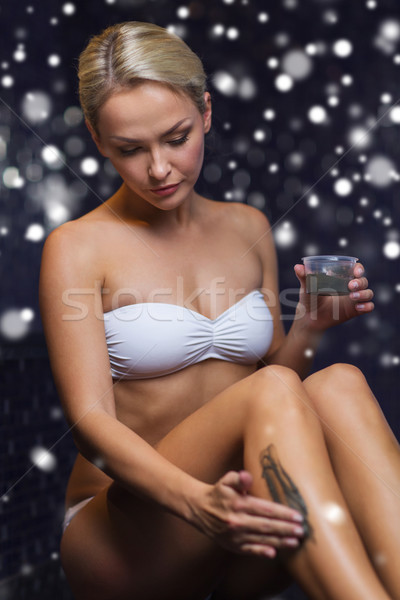 woman applying therapeutic mud in spa or sauna Stock photo © dolgachov