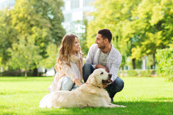 happy couple with labrador dog walking in city Stock photo © dolgachov