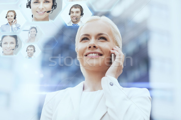 Stock photo: smiling businesswoman with smartphone outdoors