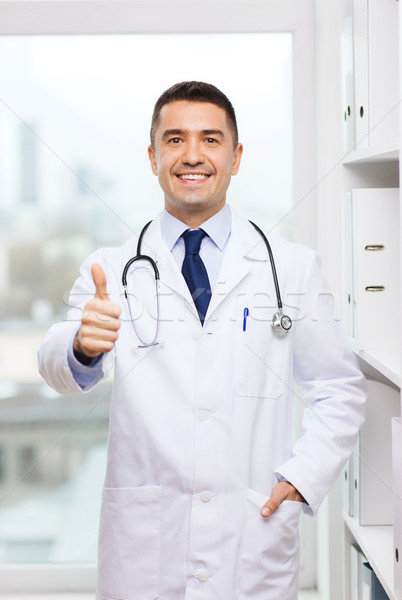 Stock photo: smiling doctor in white coat at medical office