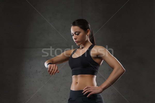 young woman with heart-rate watch in gym Stock photo © dolgachov