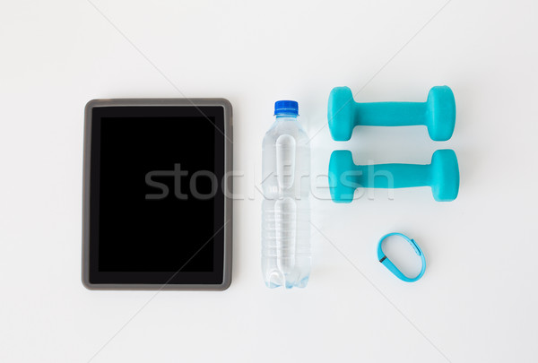 tablet pc, dumbbells, fitness tracker and bottle Stock photo © dolgachov