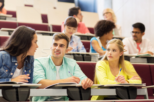 Stock photo: group of students with notebooks in lecture hall