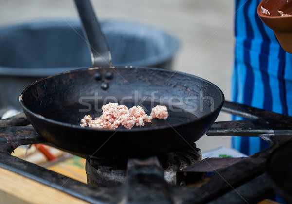 forcemeat on frying pan at street market Stock photo © dolgachov