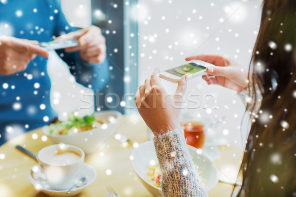 Stock photo: close up of couple picturing food by smartphone