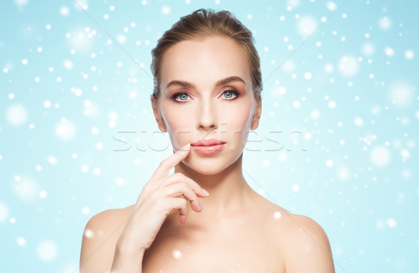 beautiful young woman showing her lips over snow Stock photo © dolgachov