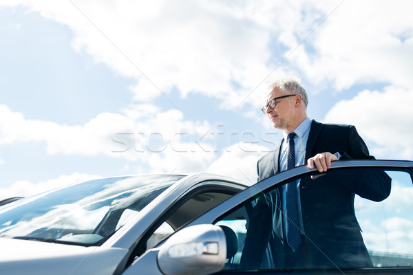 senior businessman getting into car Stock photo © dolgachov