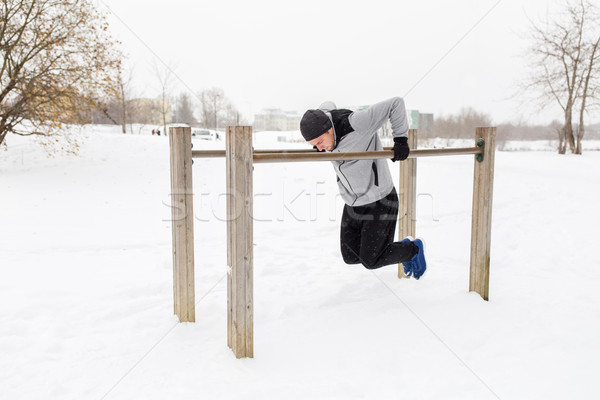 Jeune homme parallèle bars hiver fitness [[stock_photo]] © dolgachov