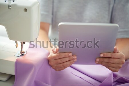 tailor with sewing machine, tablet pc and fabric Stock photo © dolgachov