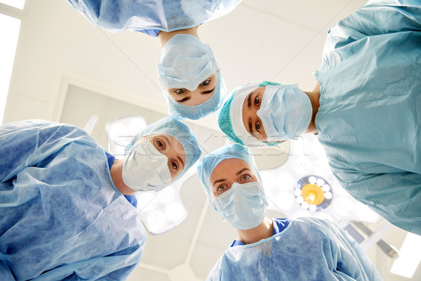 group of surgeons in operating room at hospital Stock photo © dolgachov