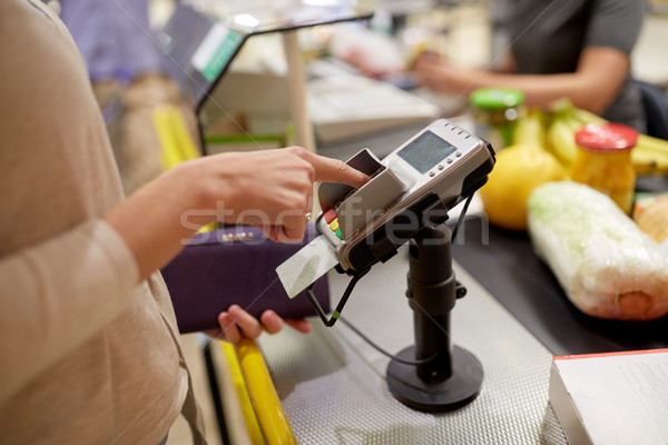 woman entering pin code at store cash register Stock photo © dolgachov
