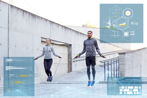 man and woman exercising with jump-rope outdoors Stock photo © dolgachov