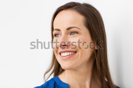 face of happy smiling middle aged woman Stock photo © dolgachov