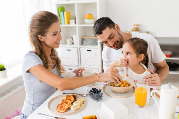 Stock photo: happy family having breakfast at home