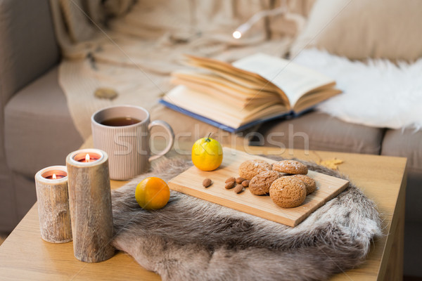 cookies, lemon tea and candles on table at home Stock photo © dolgachov