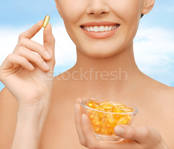 beautiful woman with omega 3 vitamins Stock photo © dolgachov