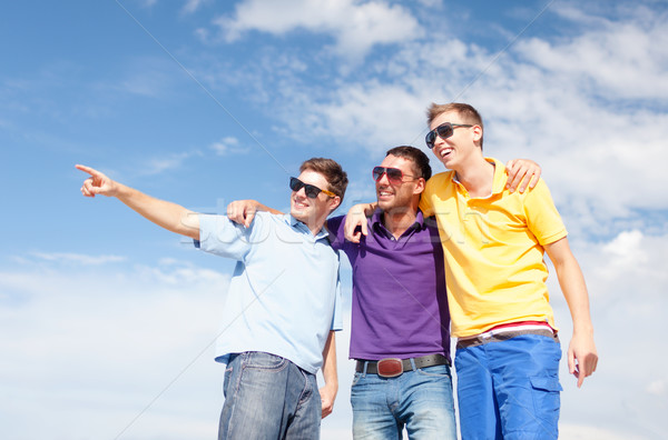 group of male friends walking on the beach Stock photo © dolgachov