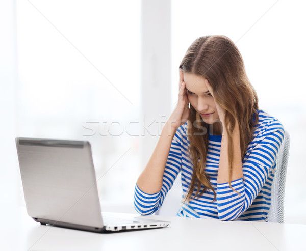 upset teenage gitl with laptop computer at home Stock photo © dolgachov