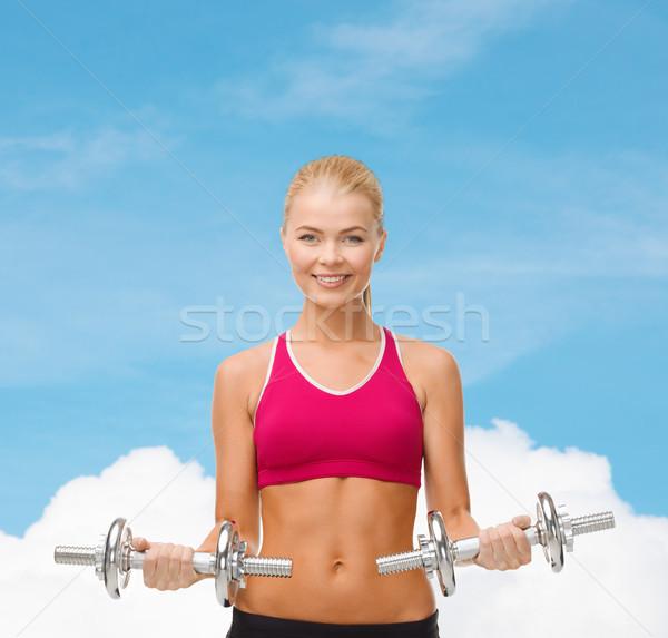 Mulher pesado aço halteres fitness saúde Foto stock © dolgachov
