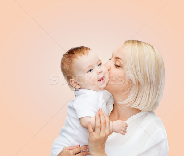 Stock photo: happy mother kissing smiling baby