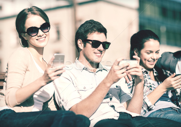 students looking at smartphones and tablet pc Stock photo © dolgachov