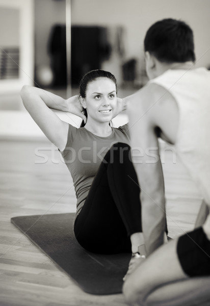 male trainer with woman doing sit ups in the gym Stock photo © dolgachov