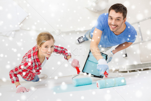 smiling couple with roll and tray painting wall Stock photo © dolgachov