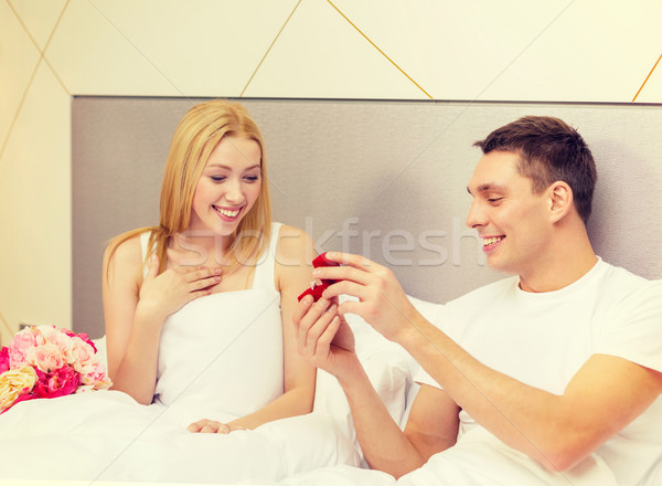 man giving woman little red box and ring in it Stock photo © dolgachov