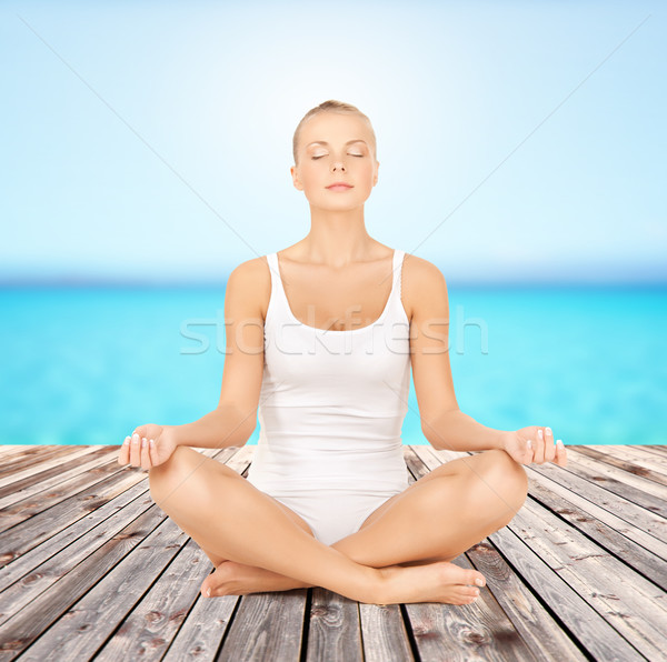 woman  meditating in yoga lotus pose  Stock photo © dolgachov