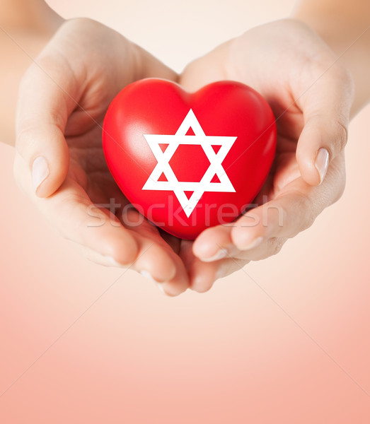 close up of hands holding heart with jewish star Stock photo © dolgachov