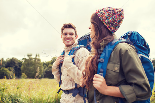 smiling couple with backpacks hiking Stock photo © dolgachov