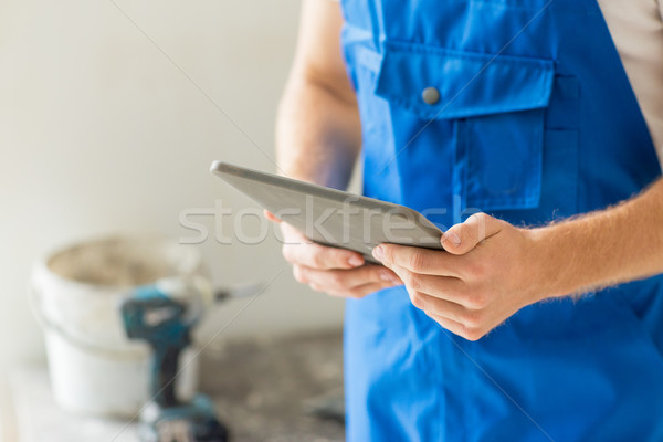 close up of builder or workman with tablet pc Stock photo © dolgachov